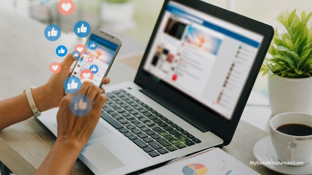 Social media management workspace with phone and laptop