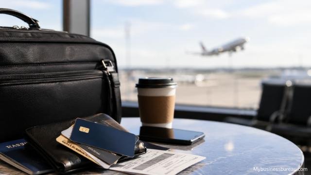 Business travel reward cards with airport essentials and flight background